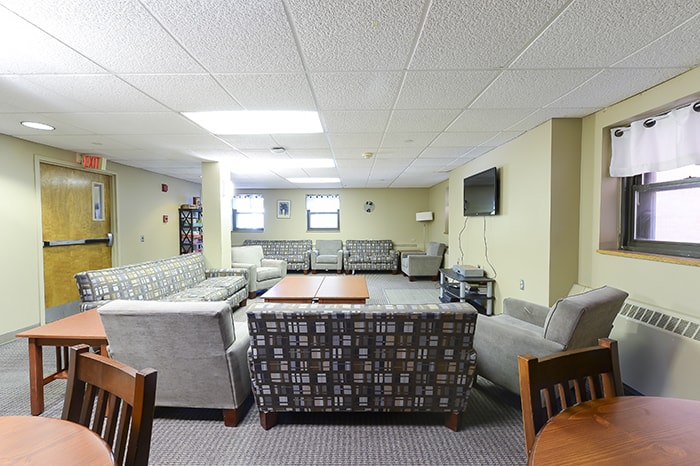 McGill House Community Space - several couches and chairs and a tv